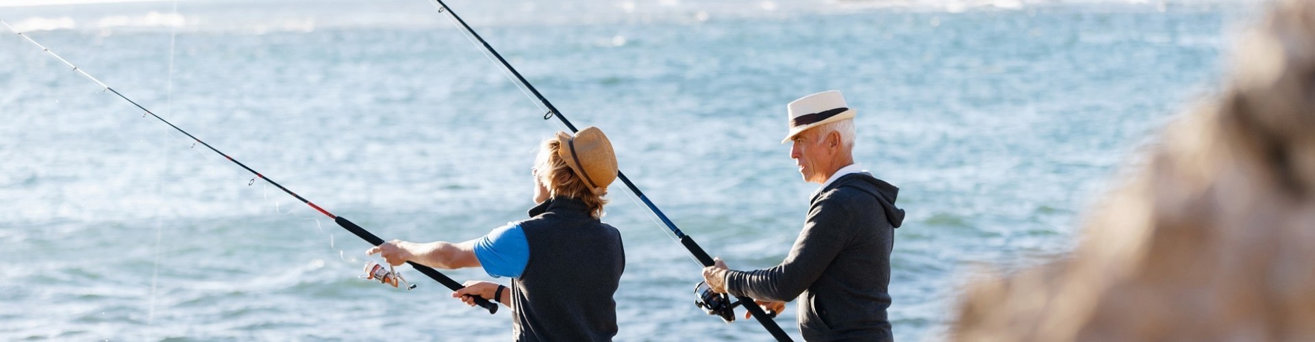 senior couple fishing at the ocean